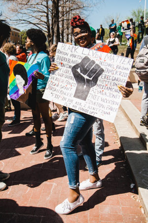 Woman holding Black Lives matter poster